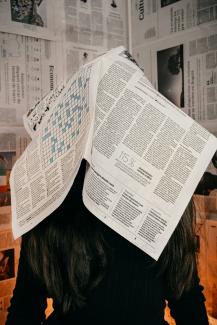 white printer paper on brown wooden table by Luis Cortés courtesy of Unsplash.